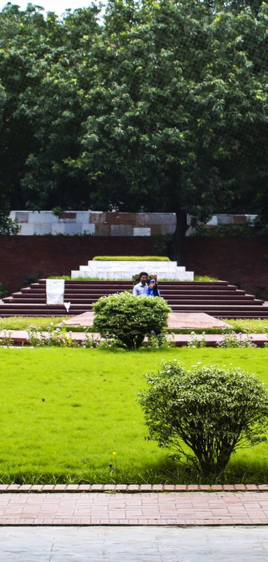 Who are the notable figures buried beside Nazrul Islam and Sharif Osman Hadi?