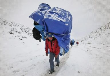 How do humans carry loads heavier than their own bodyweight?