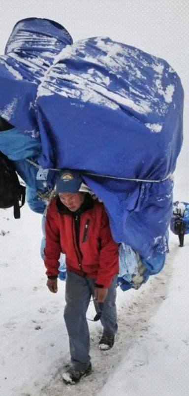 How do humans carry loads heavier than their own bodyweight?