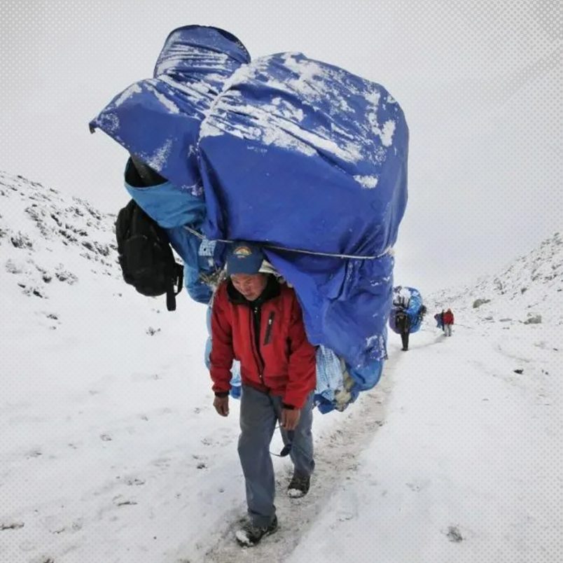 How do humans carry loads heavier than their own bodyweight?