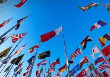 Which nationalities dominate Qatar's population?
